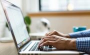 person typing on silver Macbook