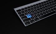 a black keyboard with a blue button on it