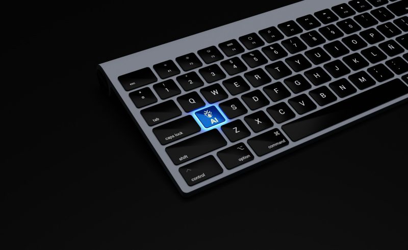 a black keyboard with a blue button on it