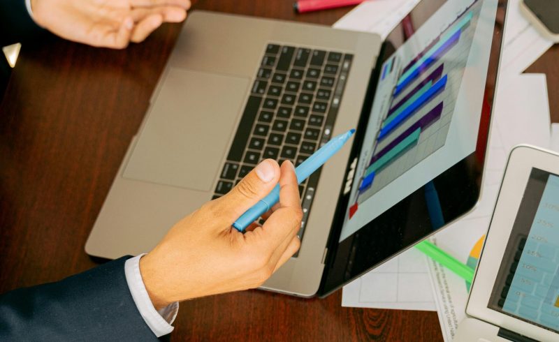 Free A Person in Black Suit Holding a Pen Stock Photo